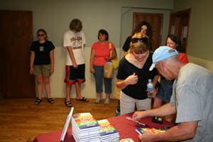 Joel signing books